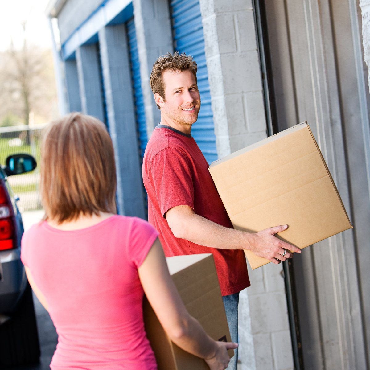 55385247_fb-image A man and a woman moving boxes into a storage unit